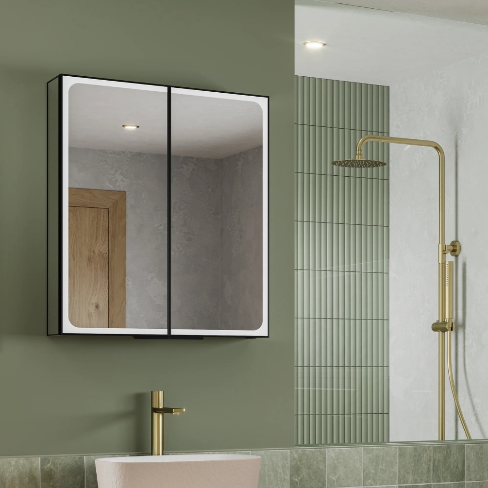 Lifestyle image of the hib. Euna 600mm x 700mm Black LED Mirror Cabinet mounted on a green bathroom wall above a freestanding basin & brass monobloc